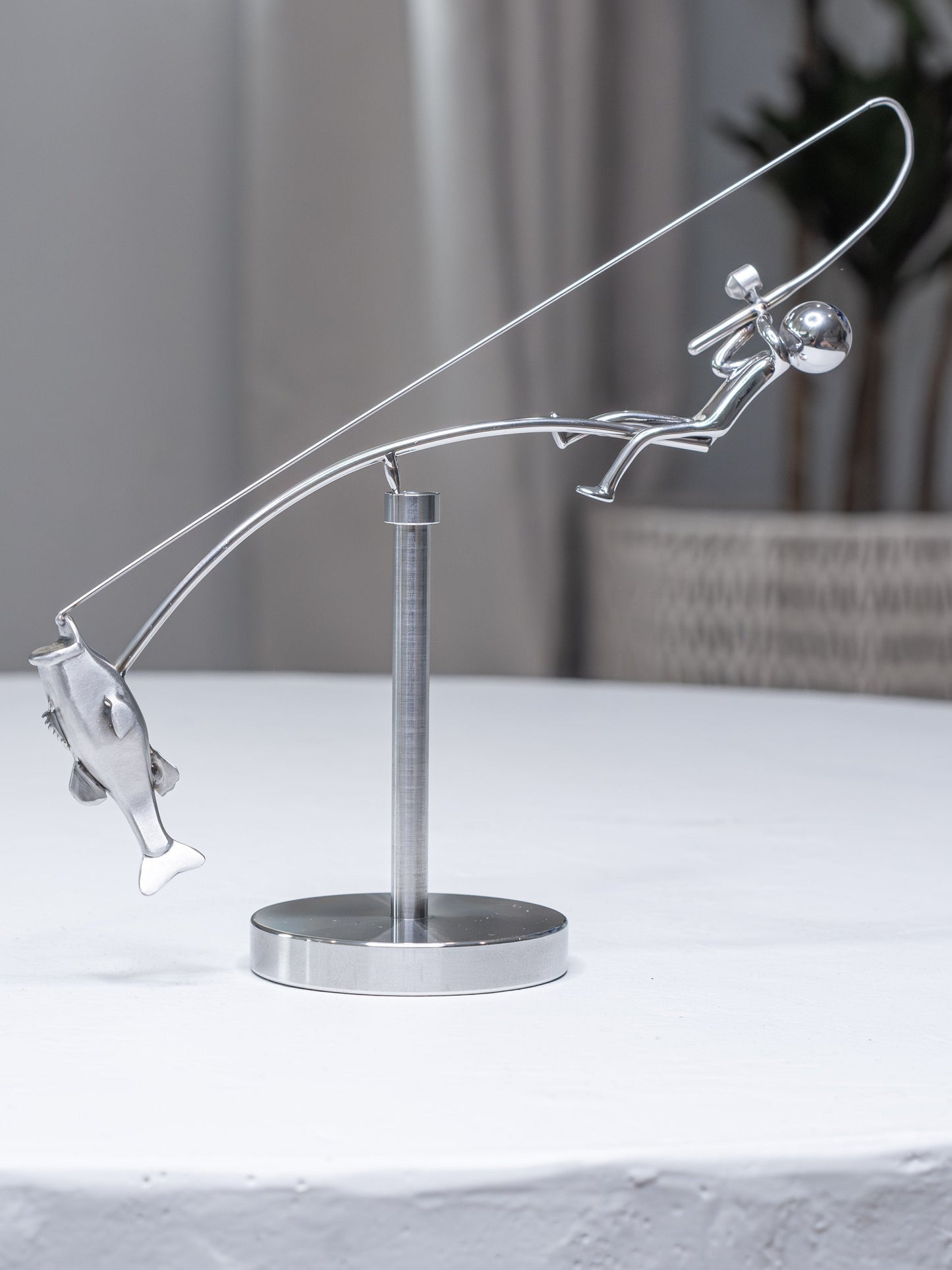 🎣Escultura del pescador en equilibrio